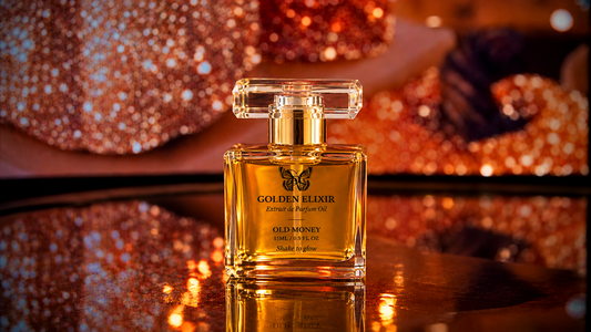 A clear glass perfume bottle labeled 'Golden Elixir' filled with amber liquid, set on a reflective dark surface with a warm, glittery orange background.